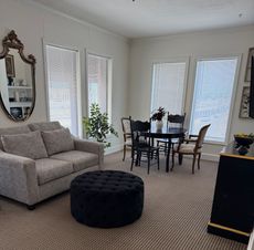 A living room with a couch a table and chairs