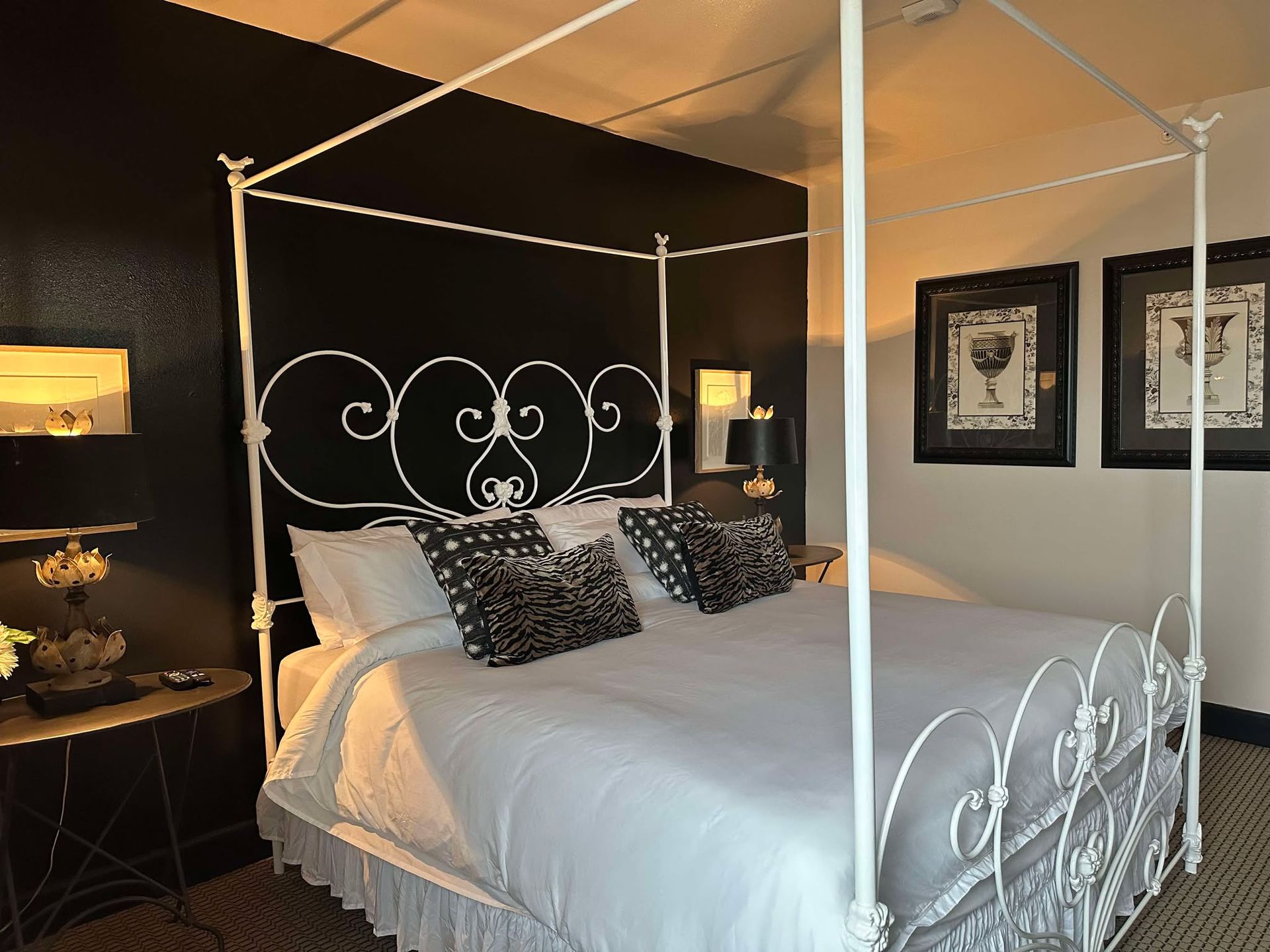 A bedroom with a canopy bed and black walls