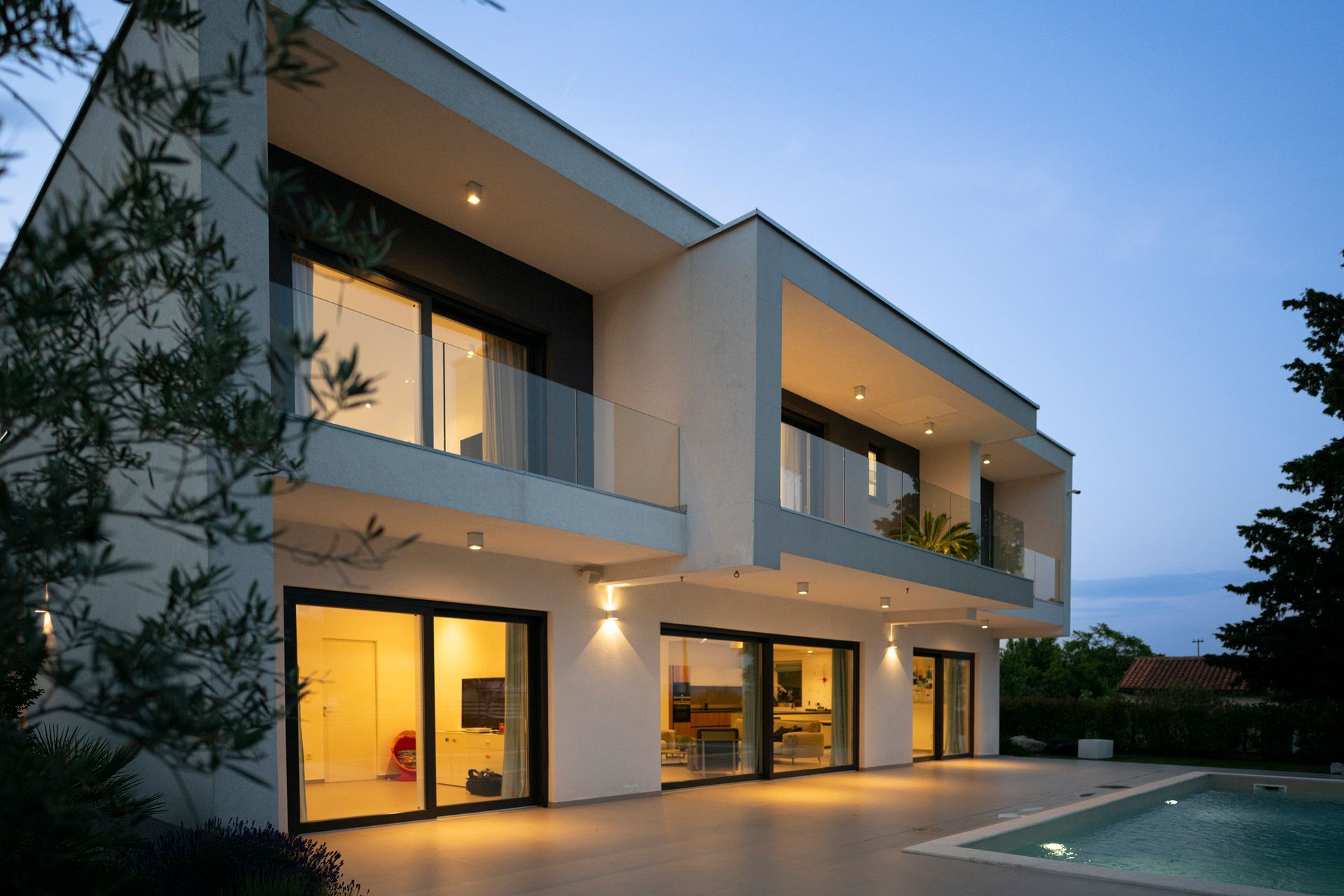 Modern luxury home exterior with pool, featuring updated residential electrical systems. Modern luxury home exterior with pool, featuring updated residential electrical systems.