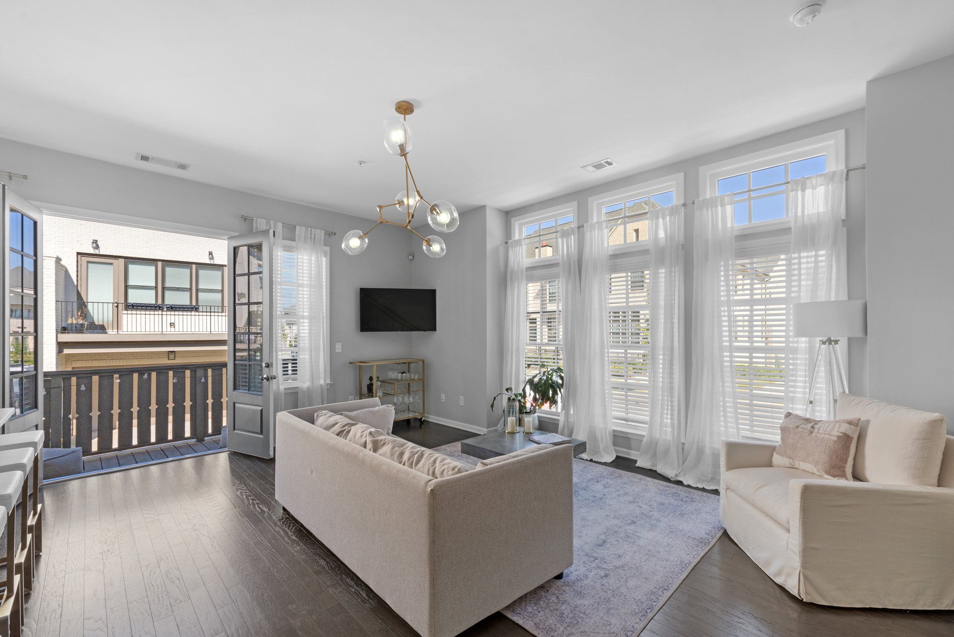 A living room with a couch , chair , and television.