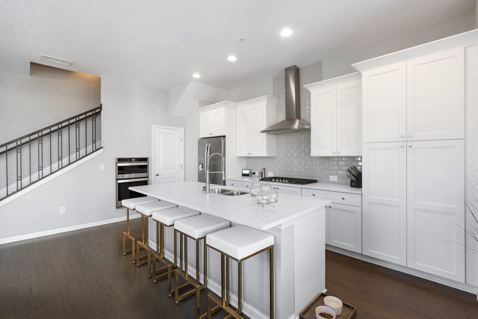 A kitchen with white cabinets and a large island