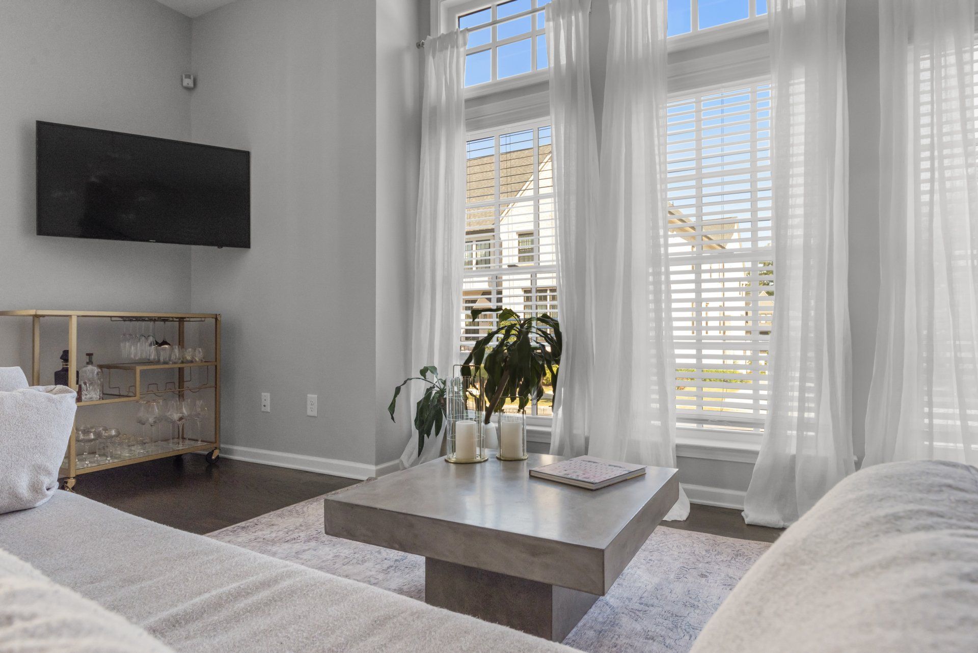 A living room with a couch , coffee table , and television.