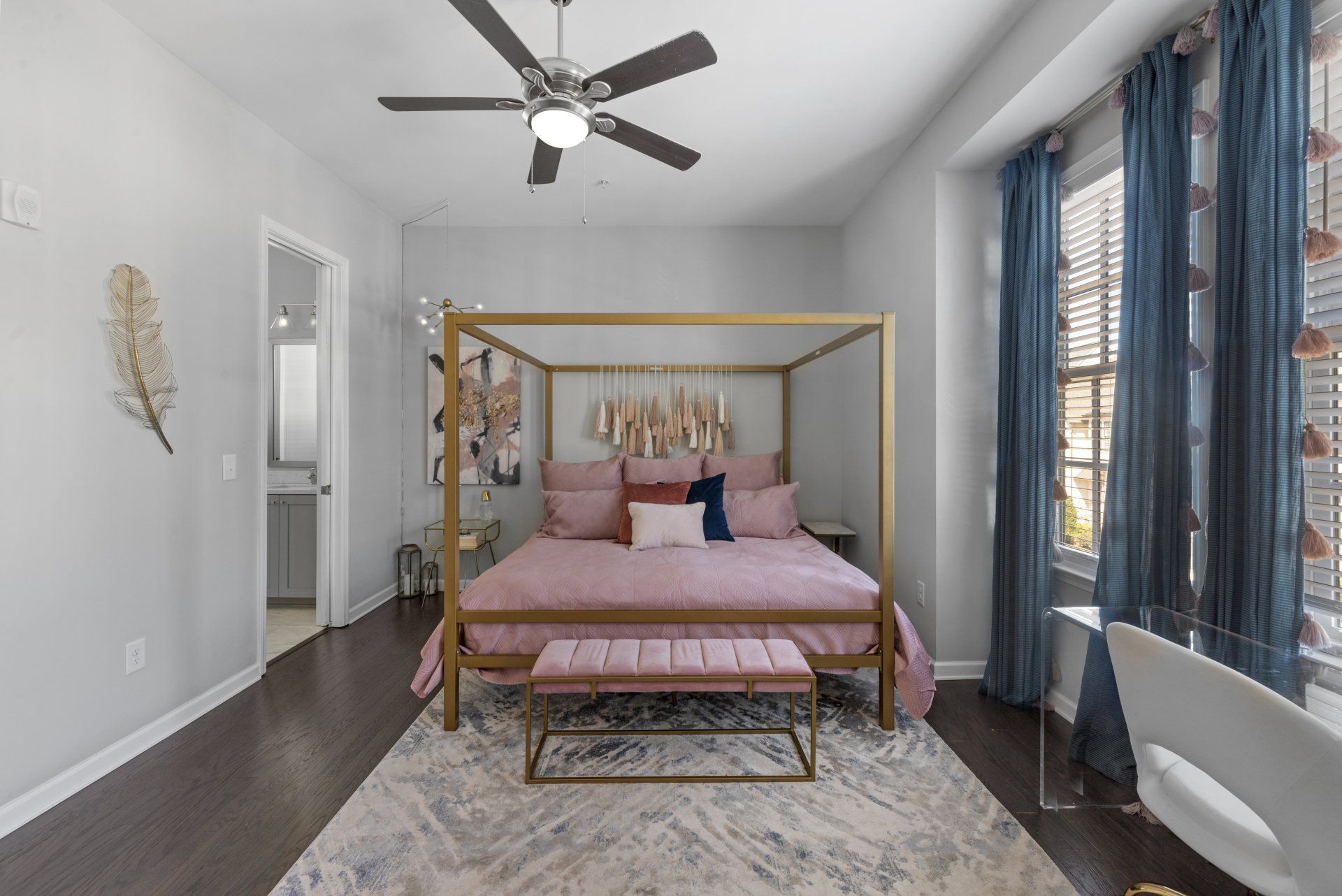 A bedroom with a canopy bed and a ceiling fan
