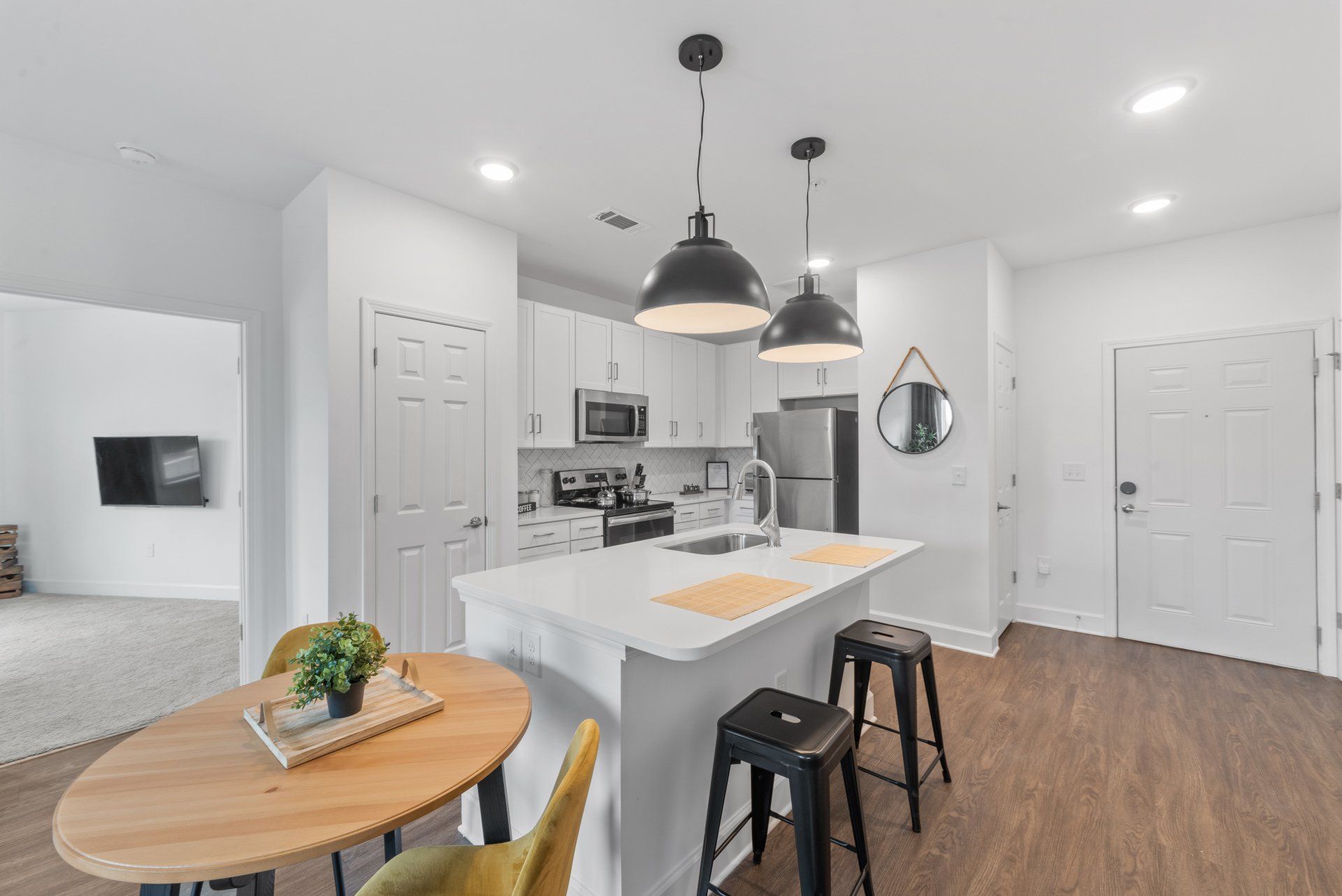 A kitchen with a table and chairs in it