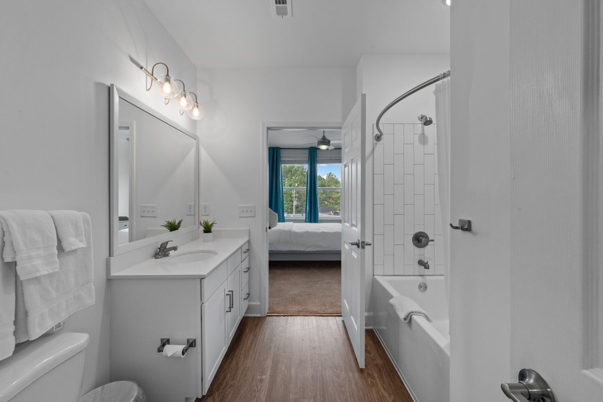 A bathroom with two sinks , a toilet , and a bathtub.