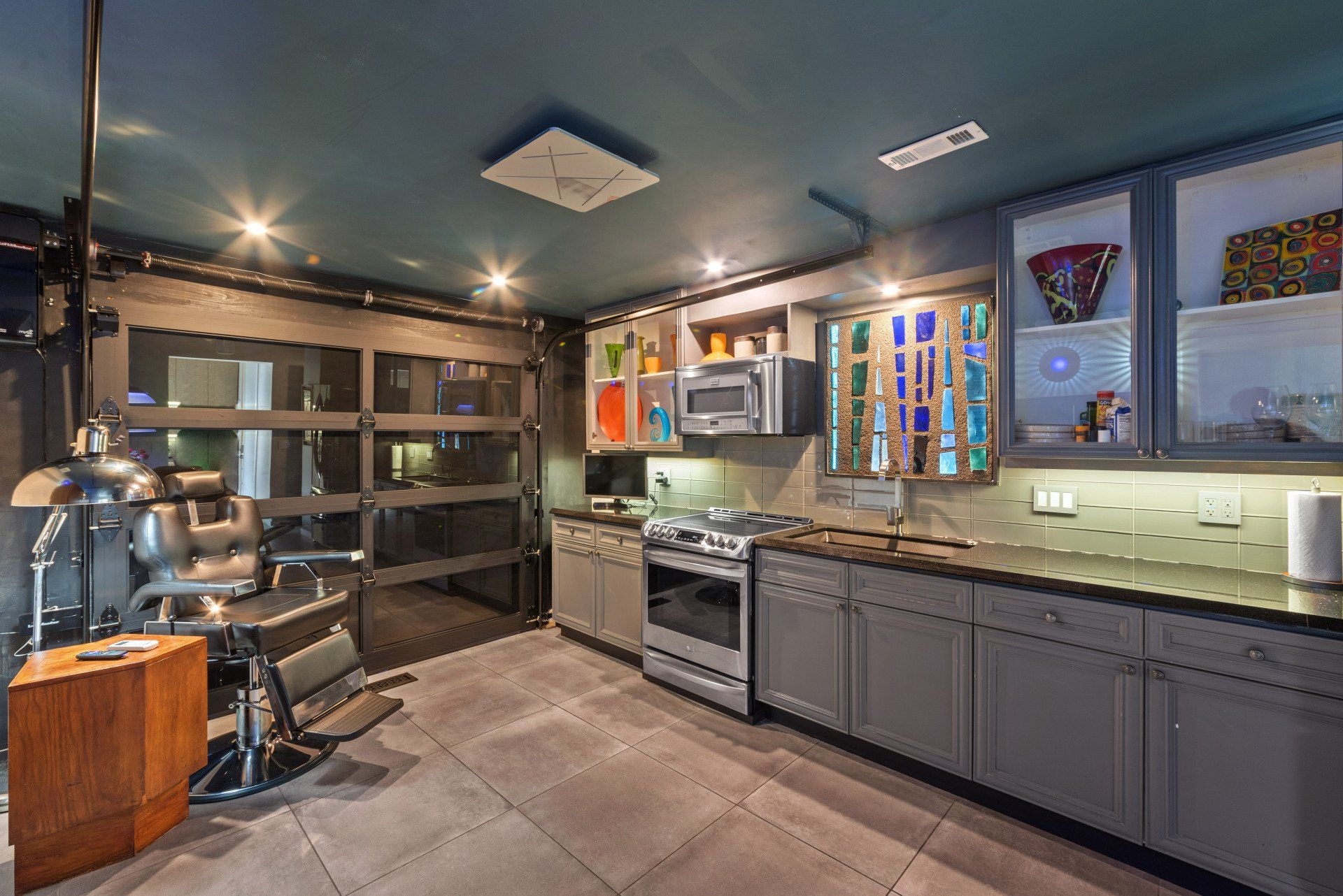A kitchen with a barber chair and a stove.