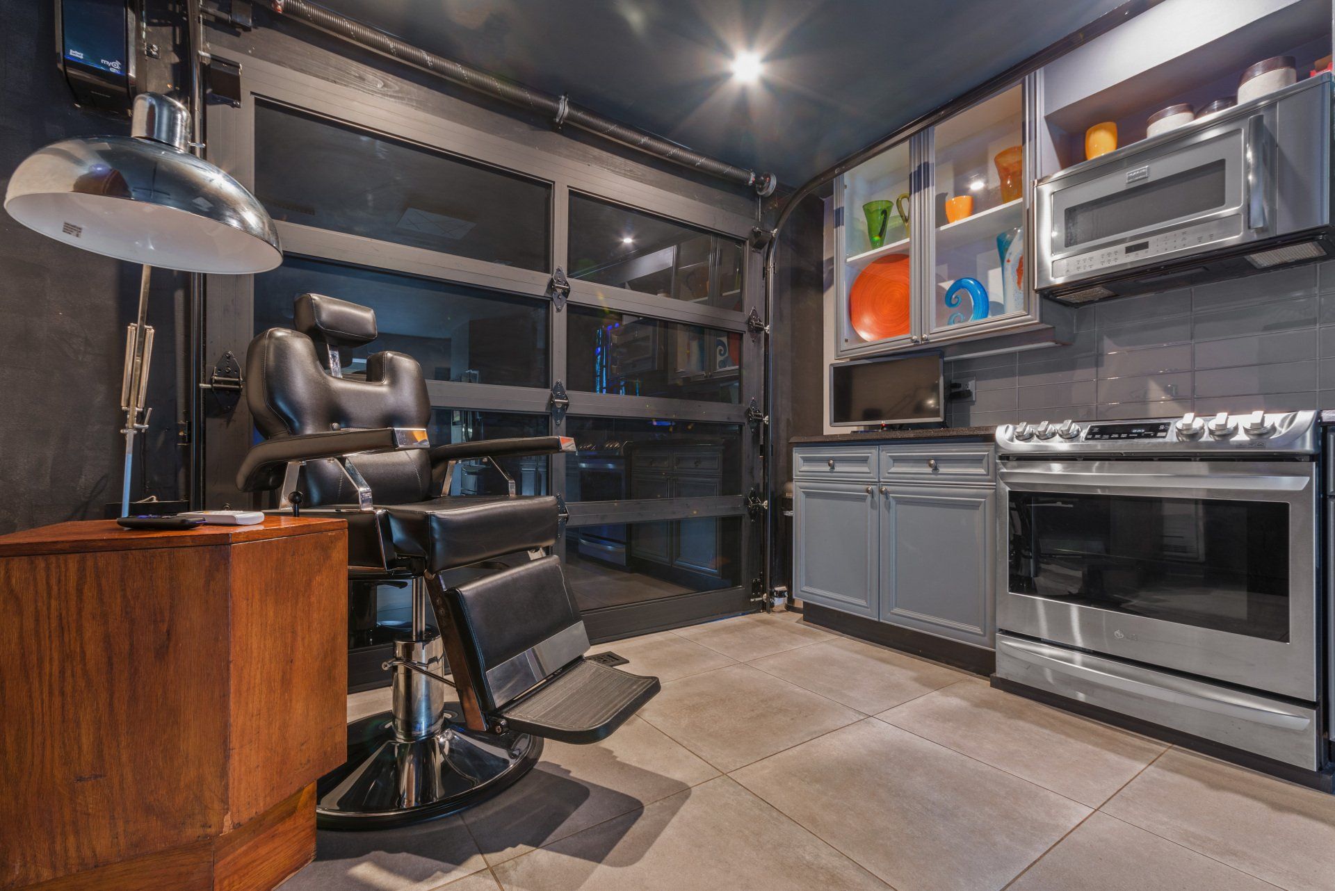 A barber chair is sitting in a kitchen next to a stove.