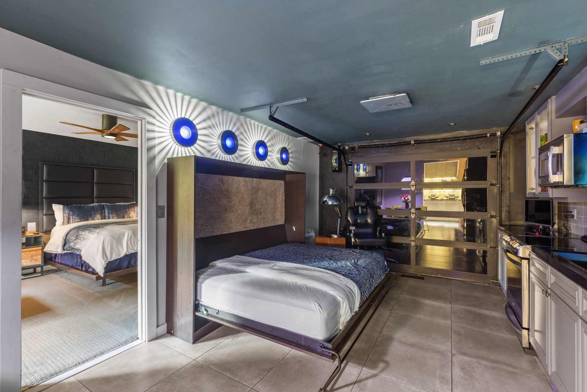 A bedroom with a bed that is pulled out of the wall.