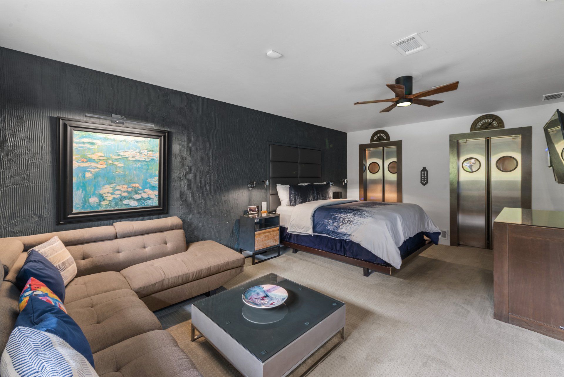 A living room with a couch , coffee table , and bed.
