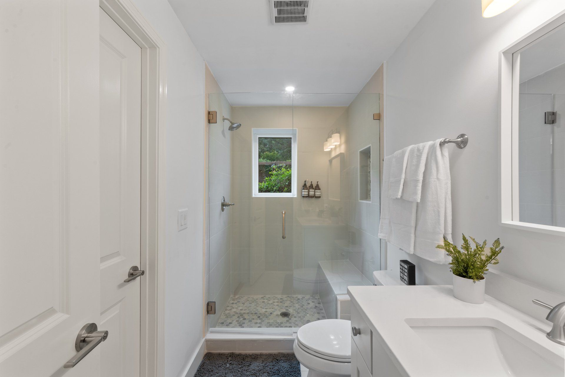 A bathroom with a toilet , sink , and shower.