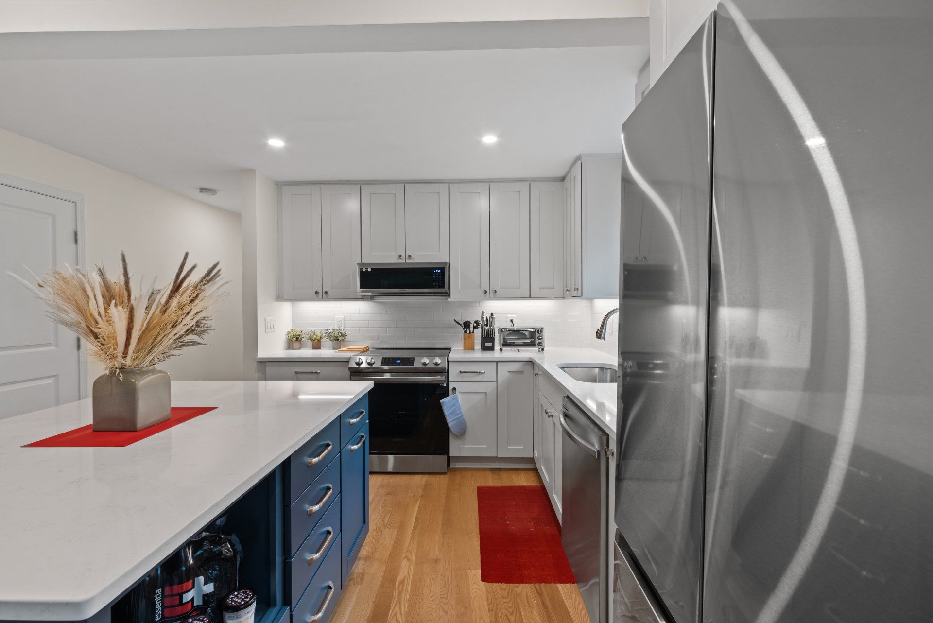 A kitchen with stainless steel appliances and white cabinets