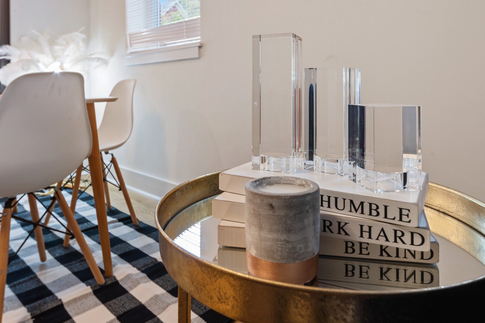 A table with a stack of books on it in a living room.
