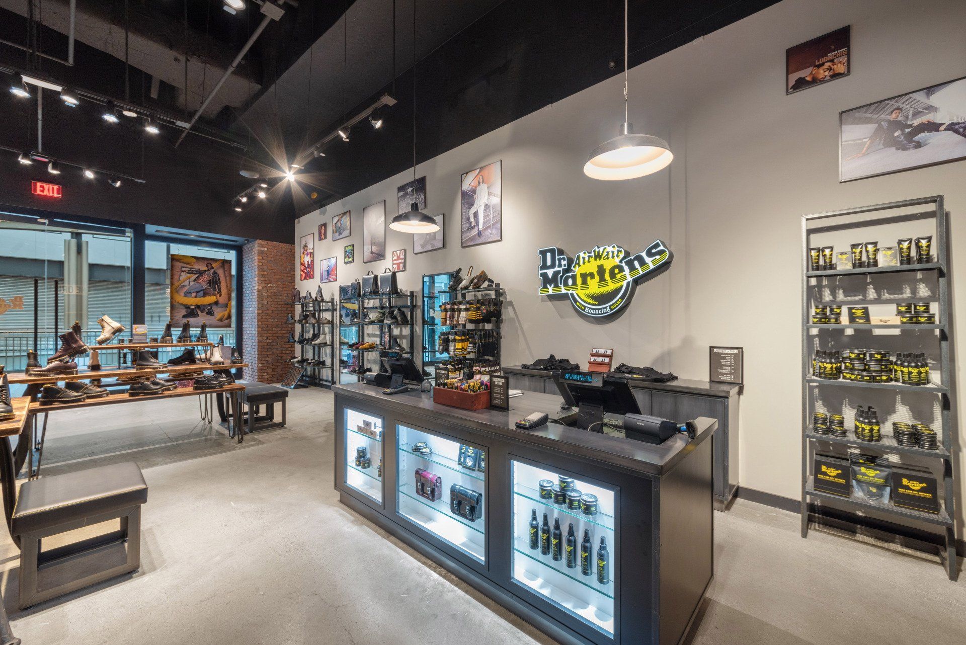 A dr. martens store with a counter in the middle of the room.
