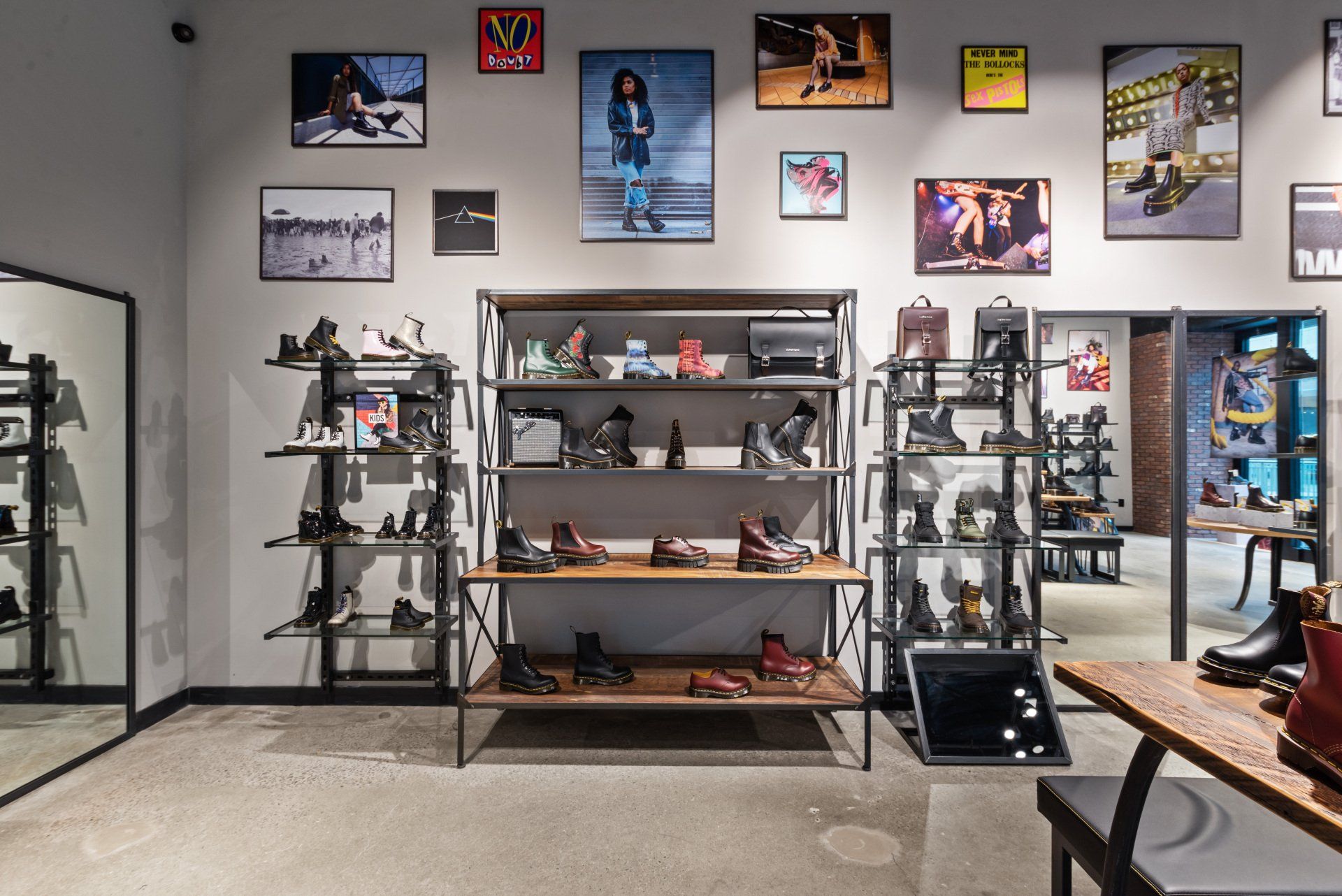 A shoe store with a lot of shelves and pictures on the wall