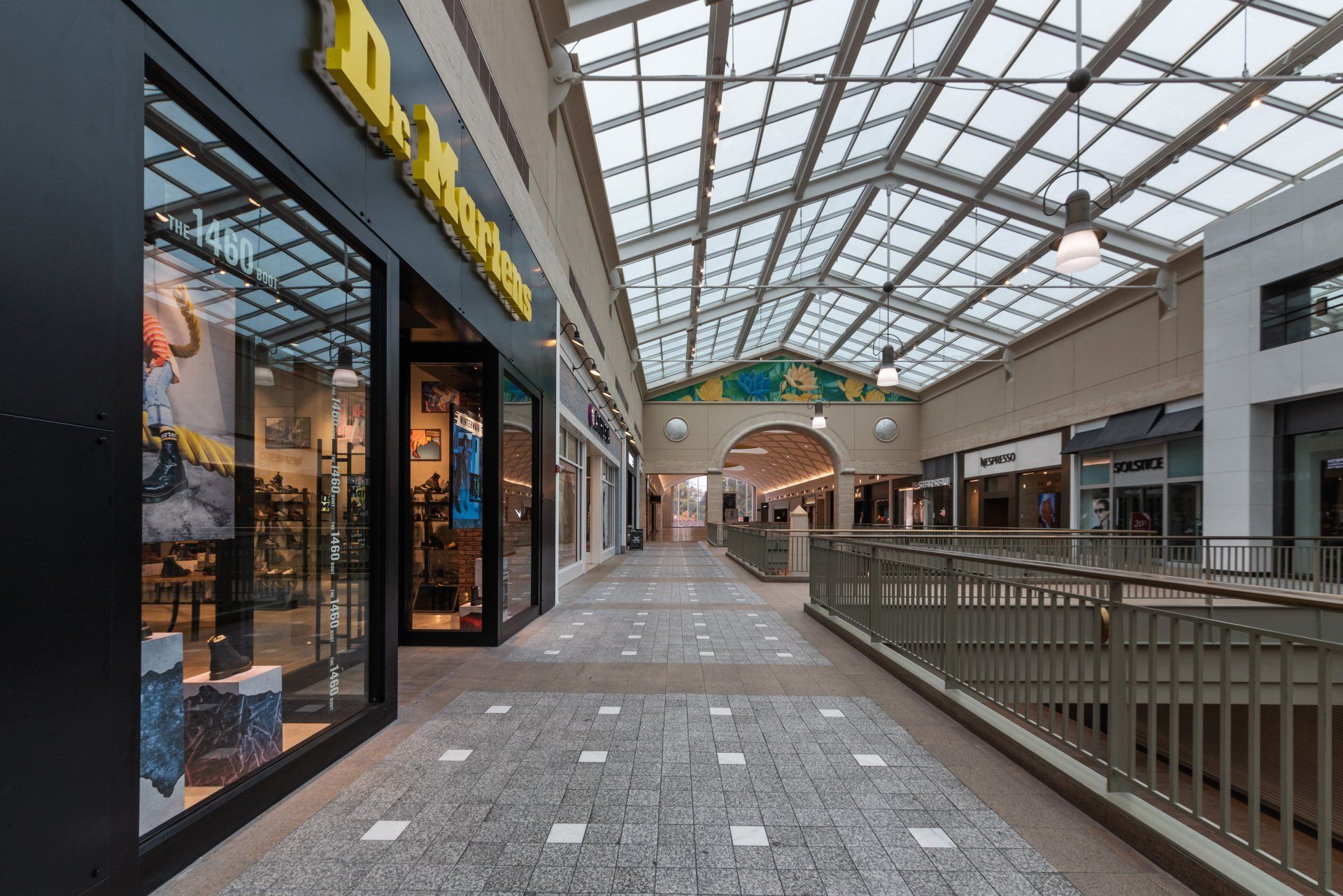 An empty mall with a dr martens store in the middle