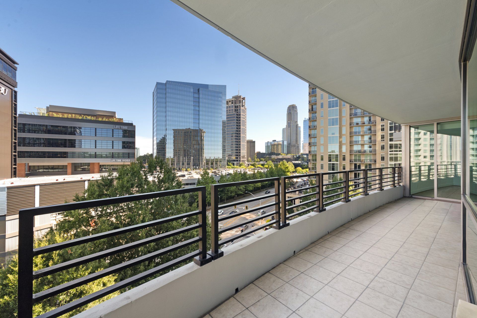 An empty balcony with a view of a city