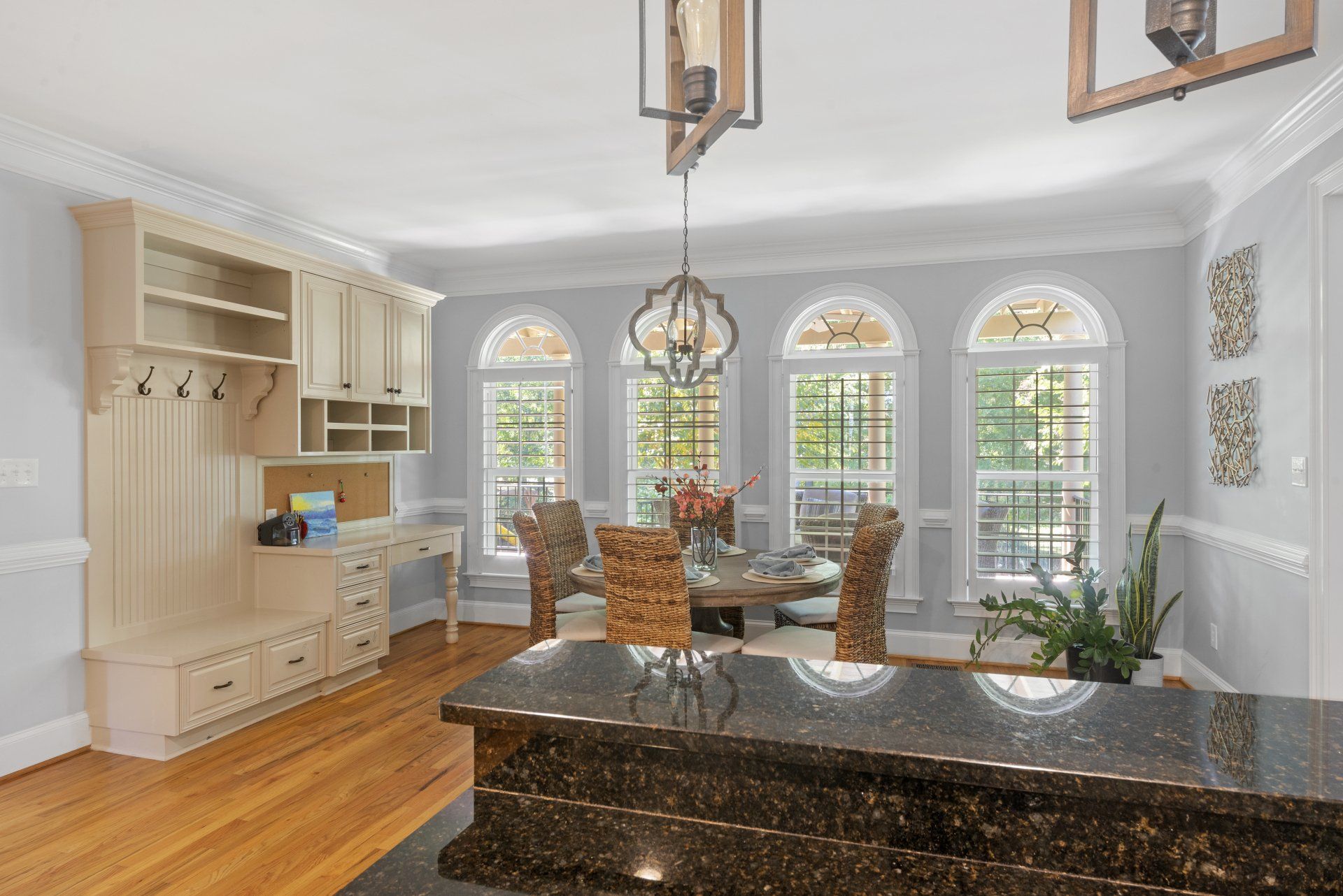 A kitchen with a large island and a dining room in the background