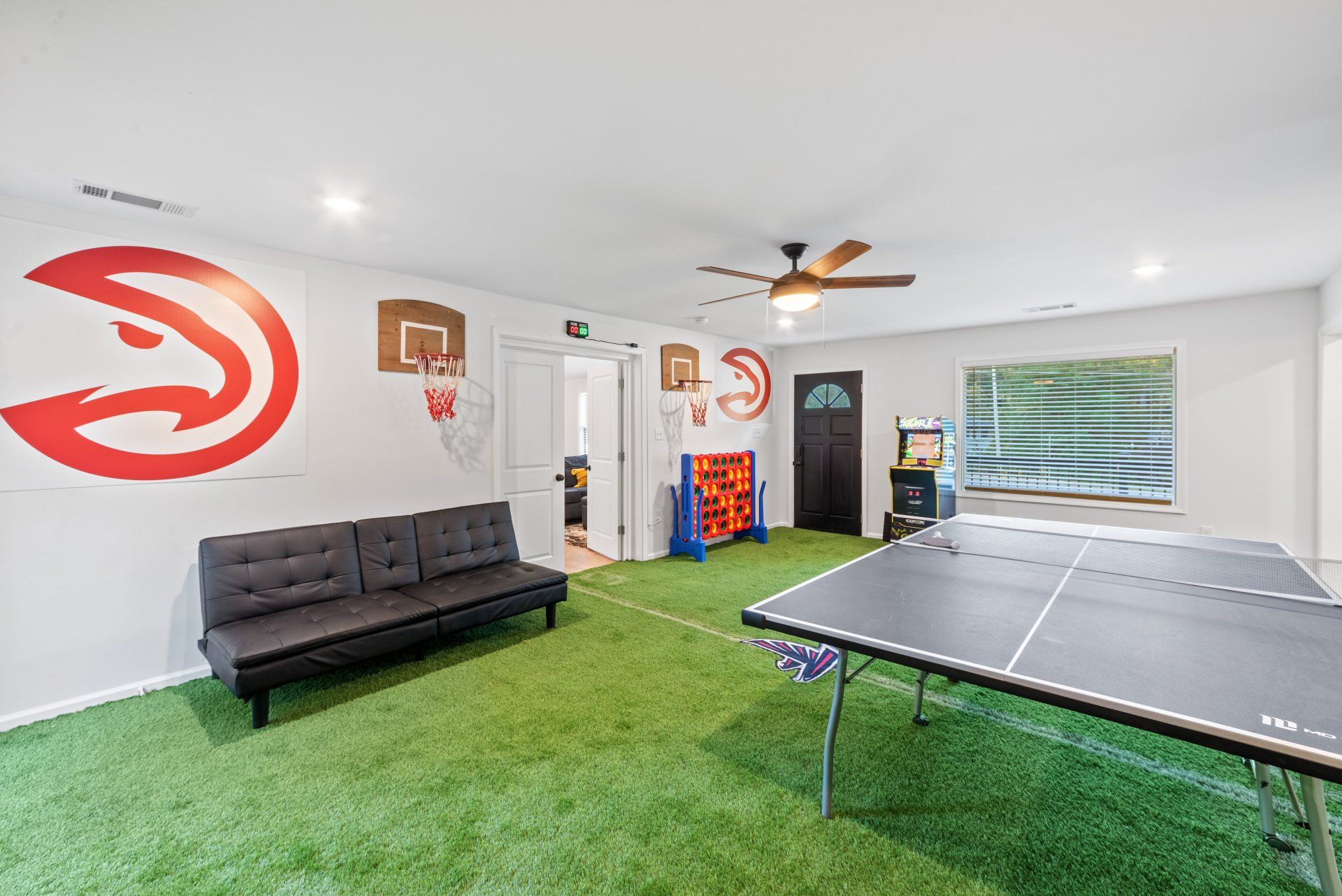 There is a ping pong table in the middle of the room.