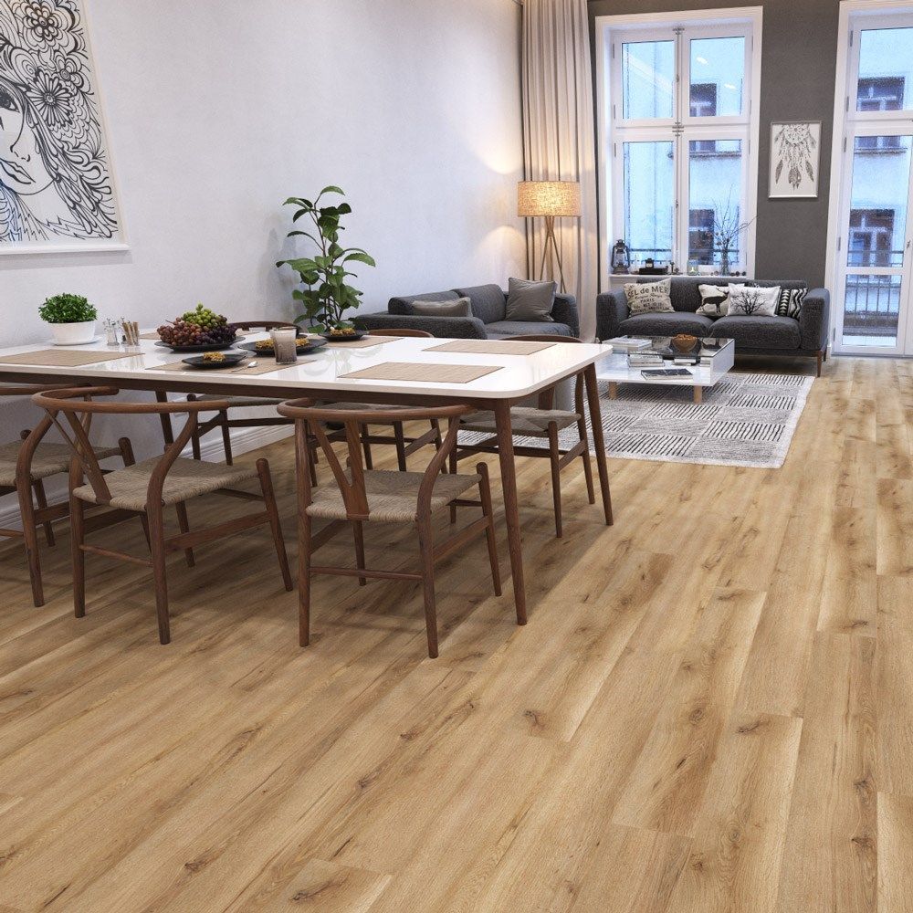 A light-filled dining and living area featuring wood floors, a wooden dining set, and gray upholstered furniture.