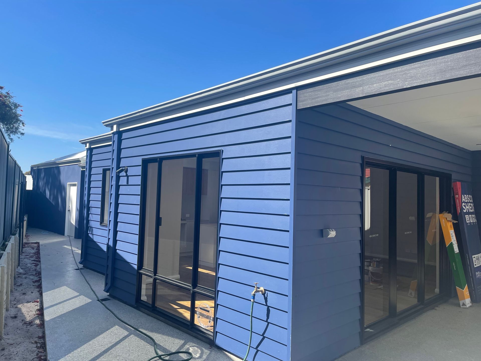 A house with blue siding and sliding glass doors