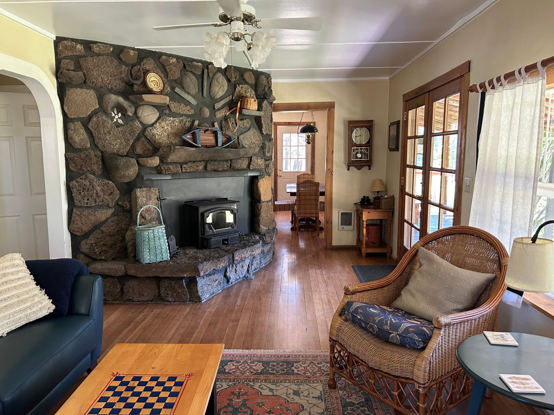 A living room with a couch , chair , table and fireplace.