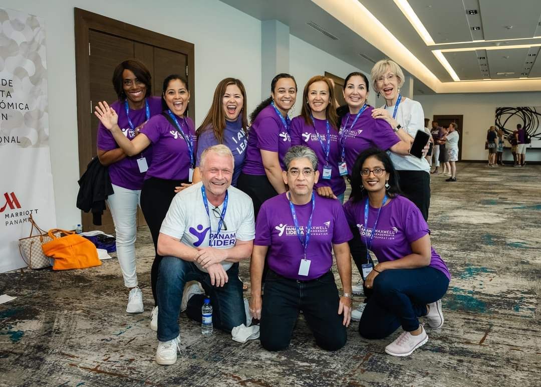 A group of people wearing purple shirts are posing for a picture.