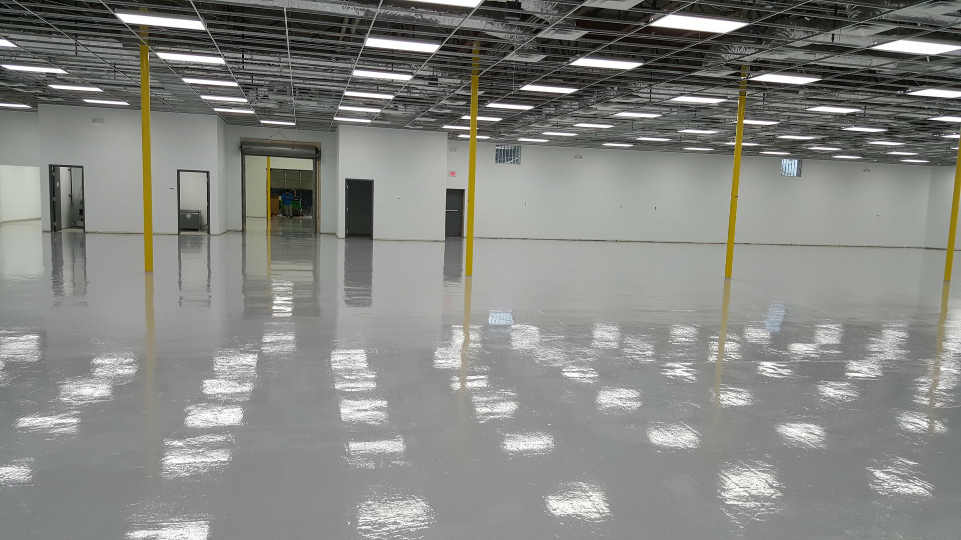 Clean, empty, brightly lit white and turquoise room. 