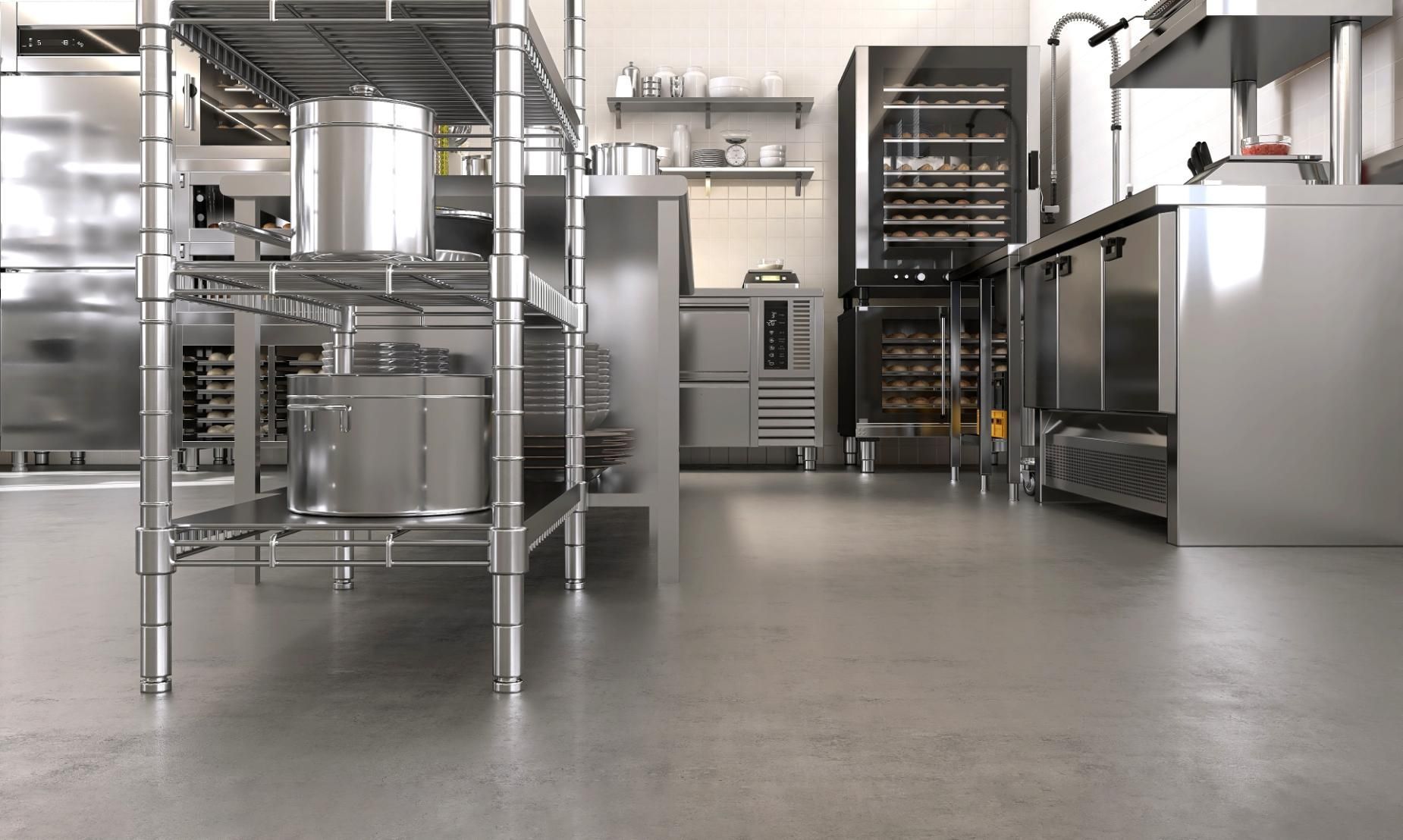 Commercial kitchen with stainless steel equipment and shelving.