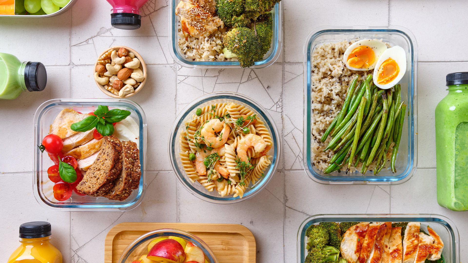 A variety of healthy food in glass containers on a table.