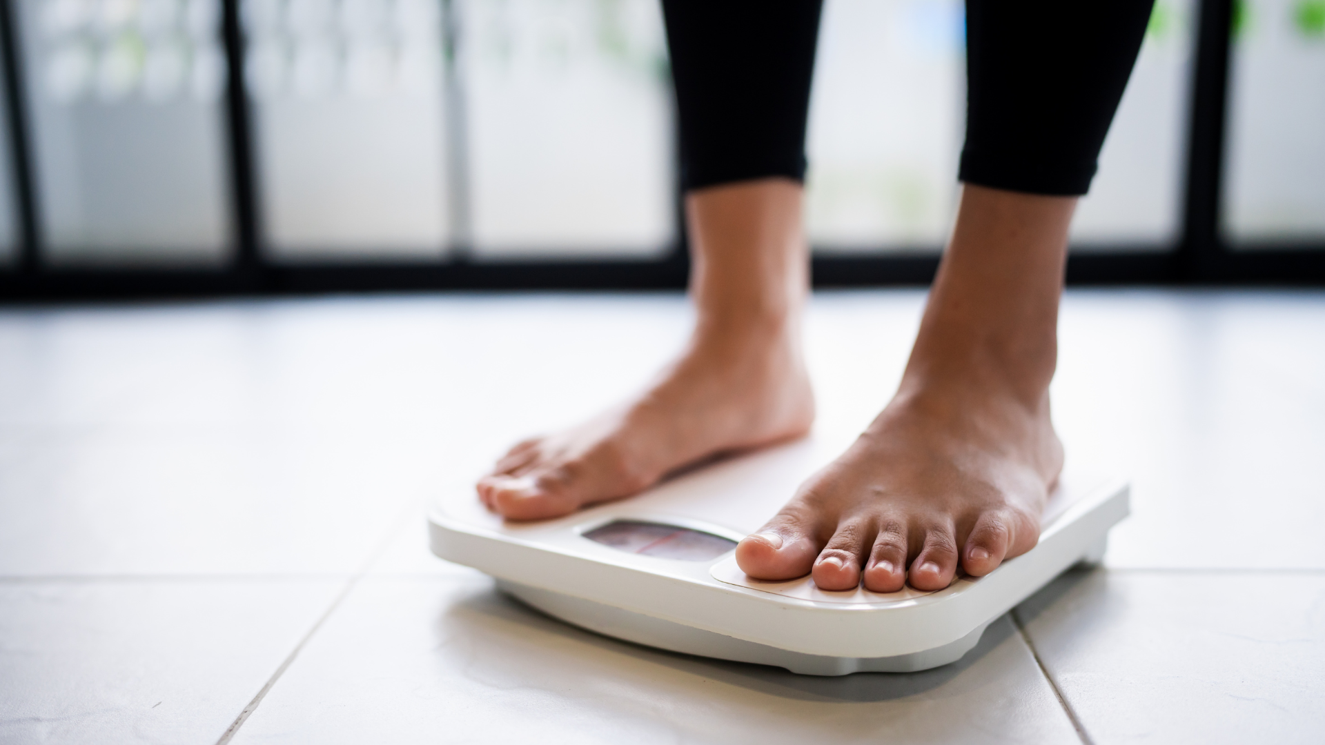 A woman is standing on a scale.