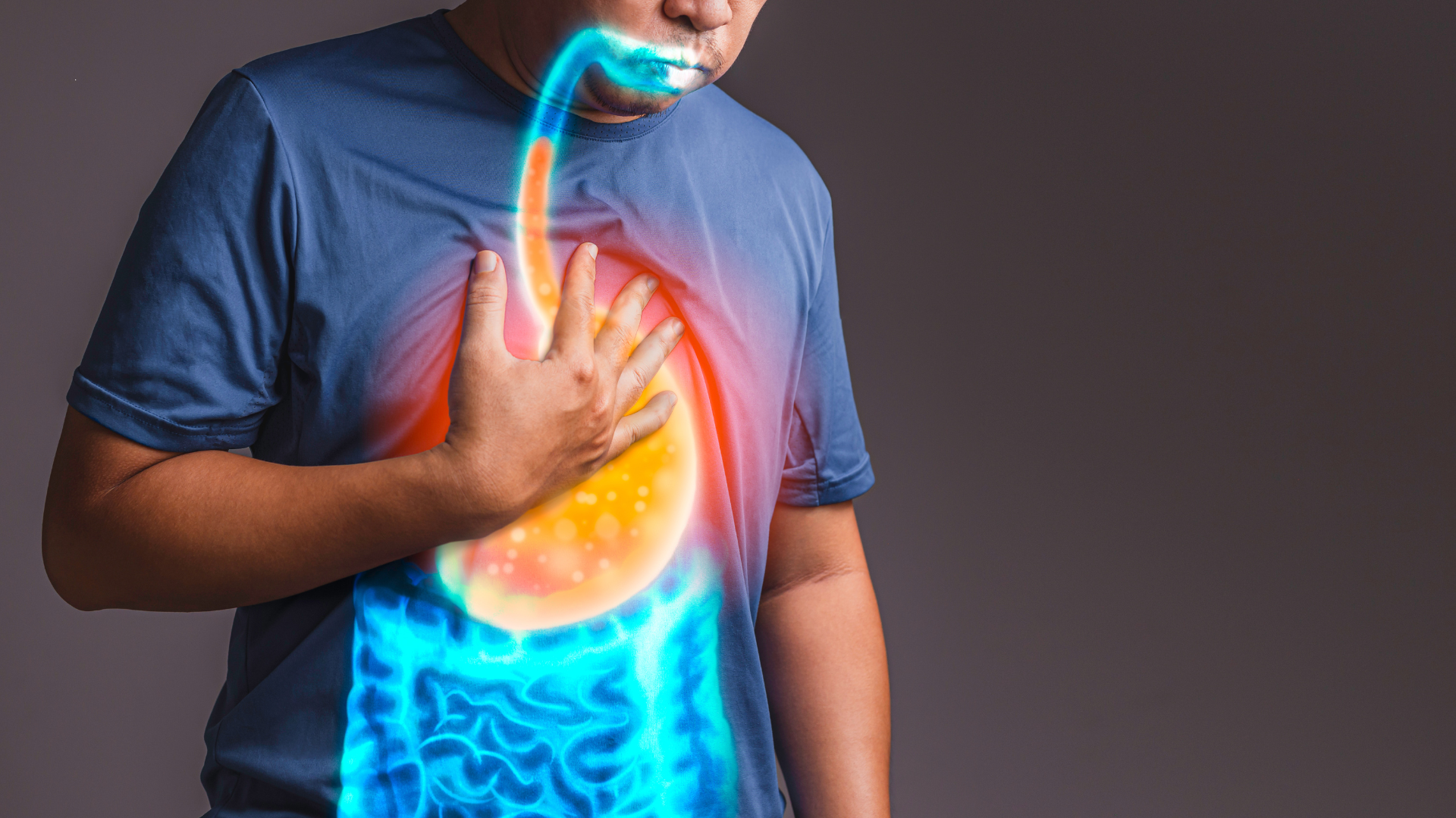 A man is holding his chest because he has acid reflux