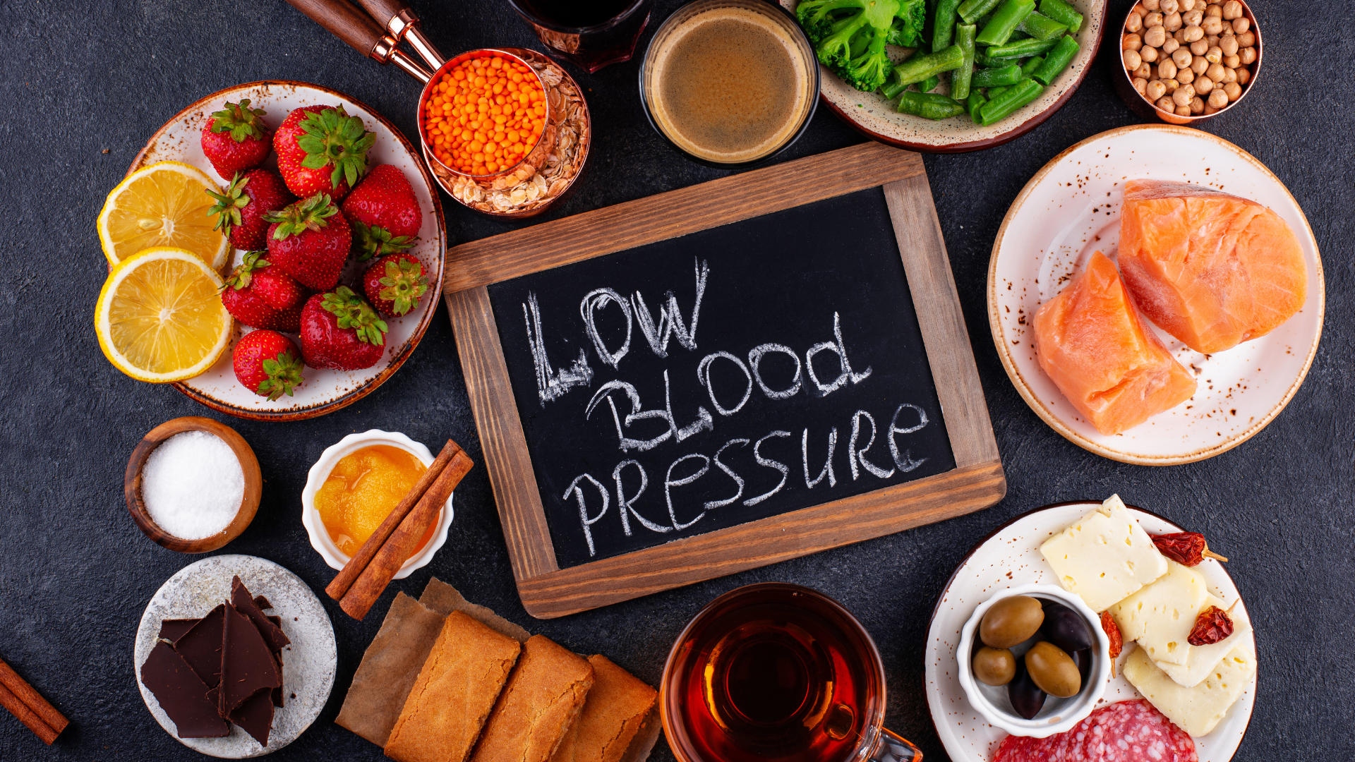 A table topped with plates of food and a sign that says `` low blood pressure ''.