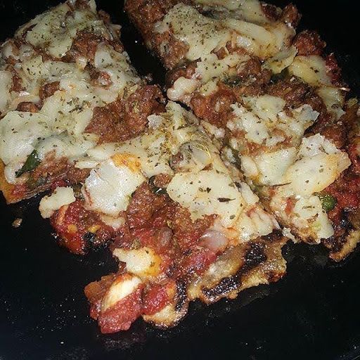 A close up of a pizza with tomato sauce and cheese