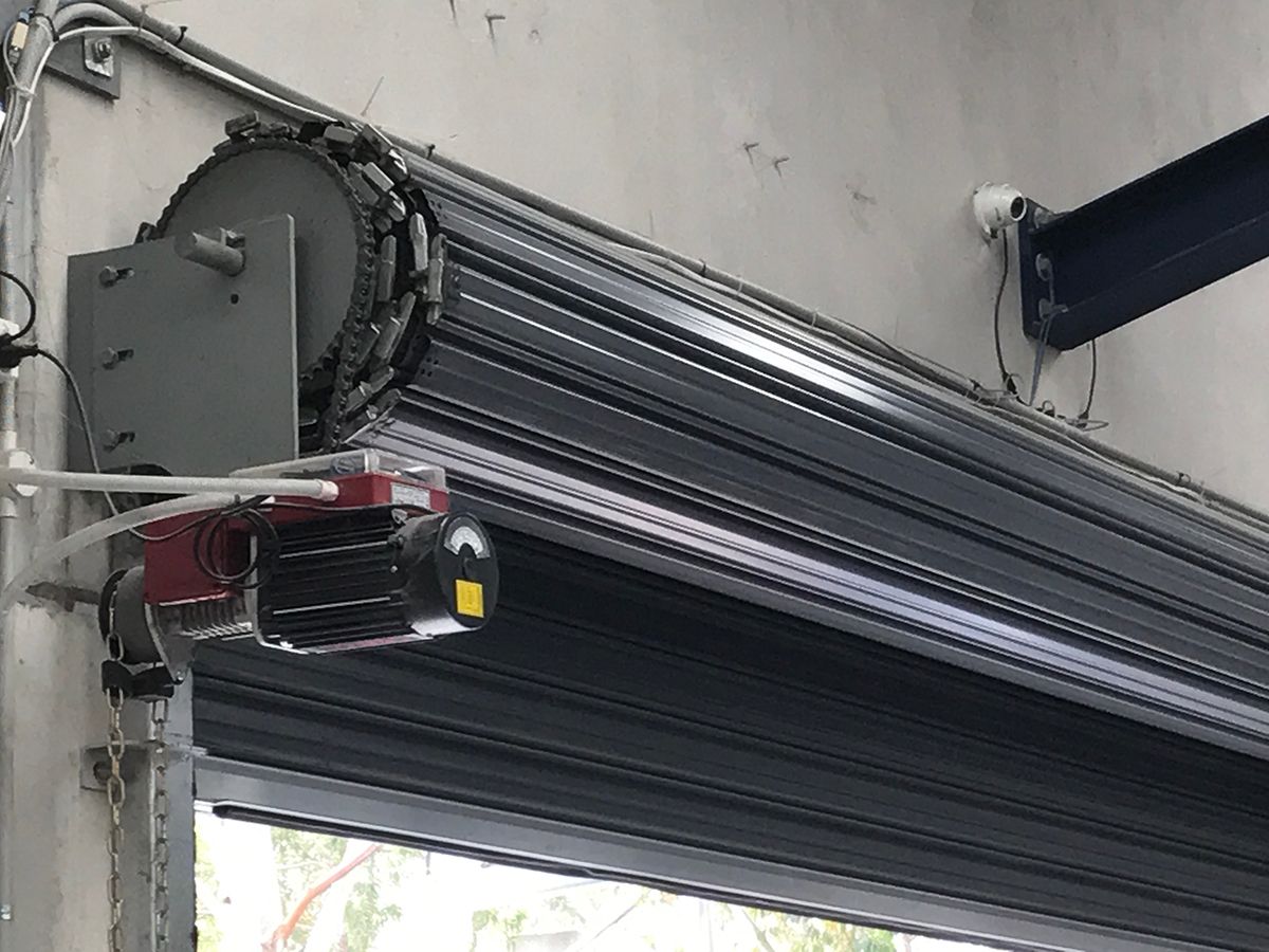 A close up of a garage door with a motor attached to it.