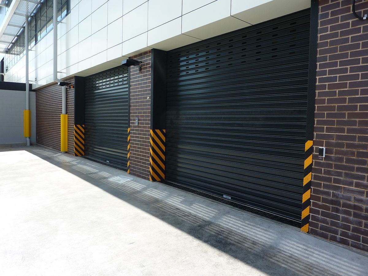 A row of garage doors on a brick building