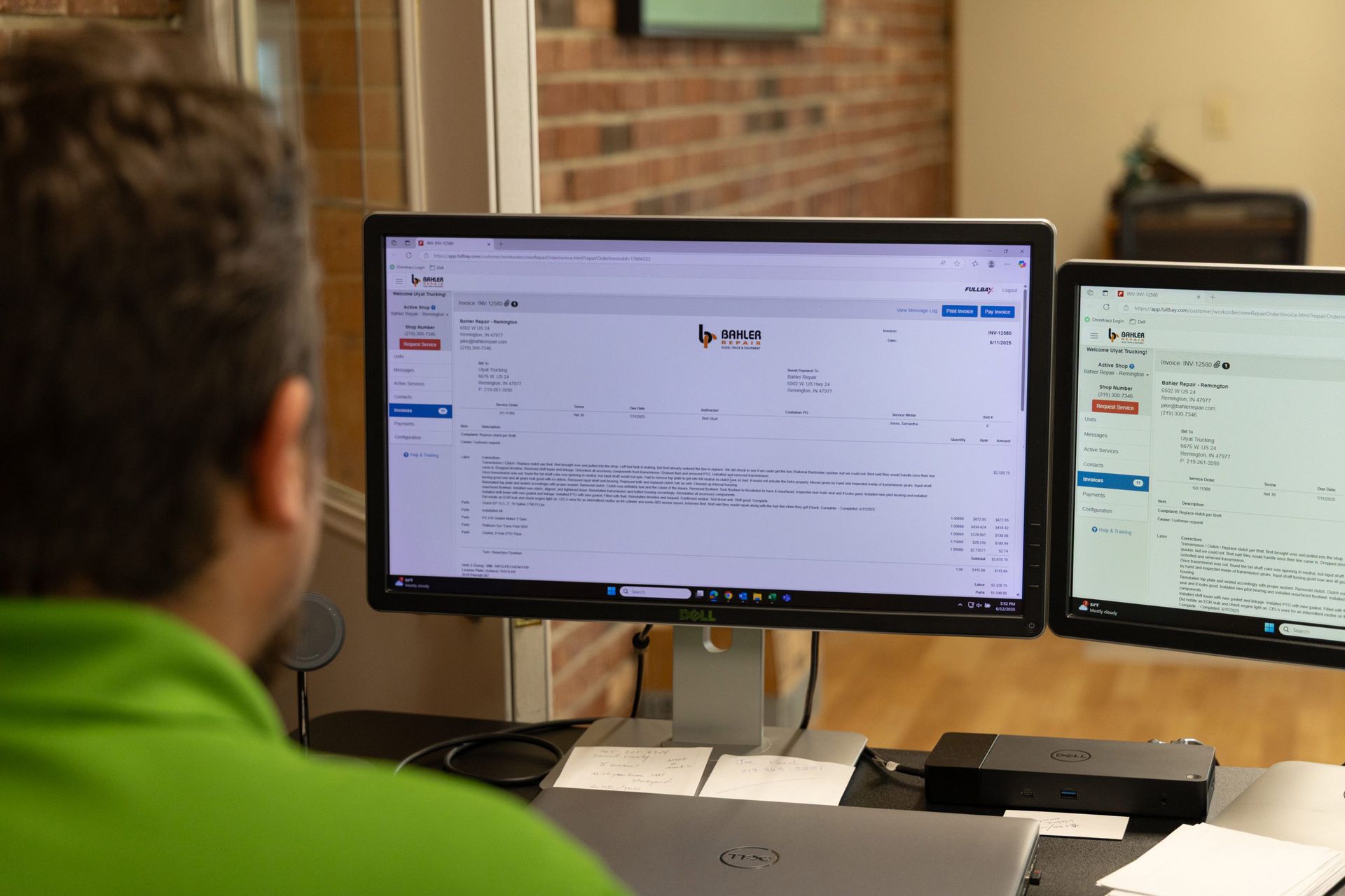 Person looking at a computer monitor displaying a dashboard, with a second monitor showing data, in an office setting.