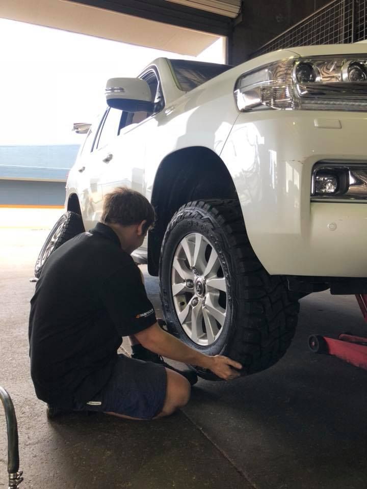 A Man Checking a Tire of A White Truck — Torque Tyres & Trailer Spares Cairns in Cairns, QLD