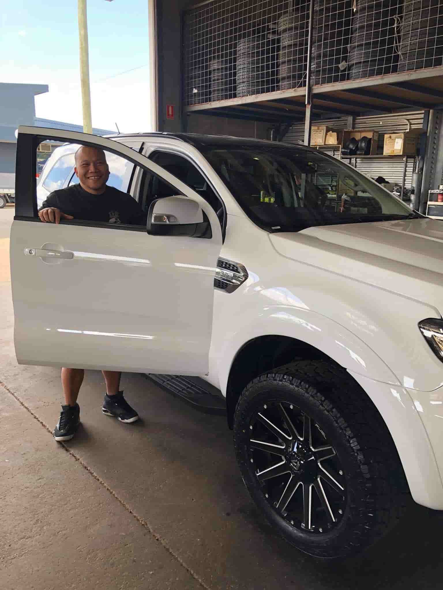 A Man Standing Next to A White Truck  — Torque Tyres & Trailer Spares Cairns in Cairns, QLD