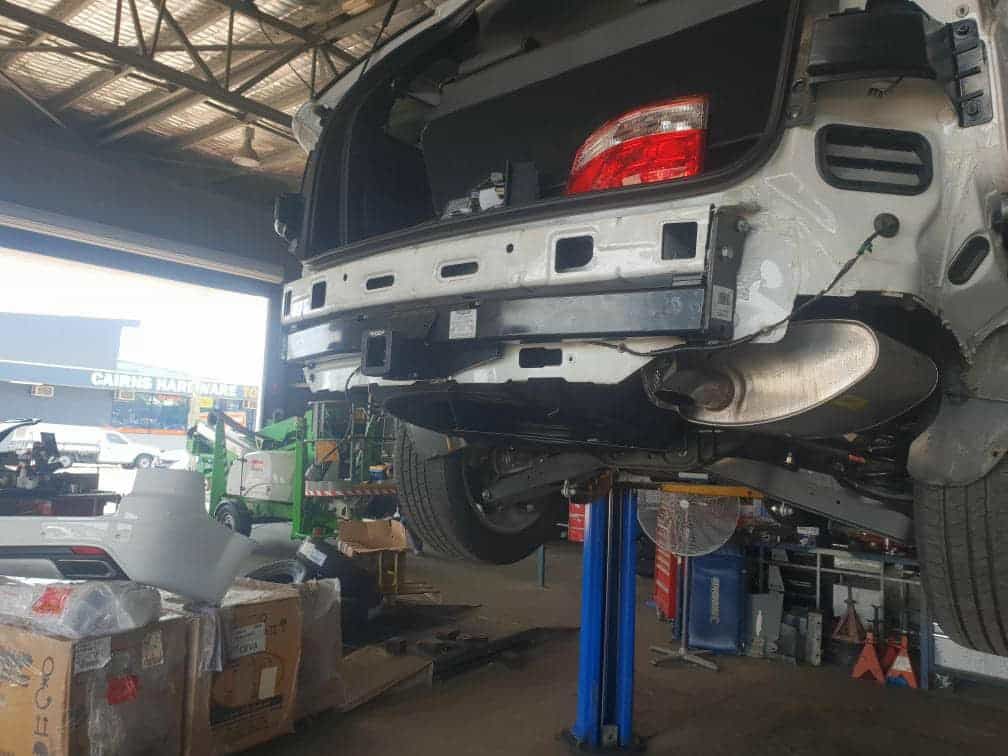 A Car Is Sitting on A Lift in A Garage — Torque Tyres & Trailer Spares Cairns in Cairns, QLD