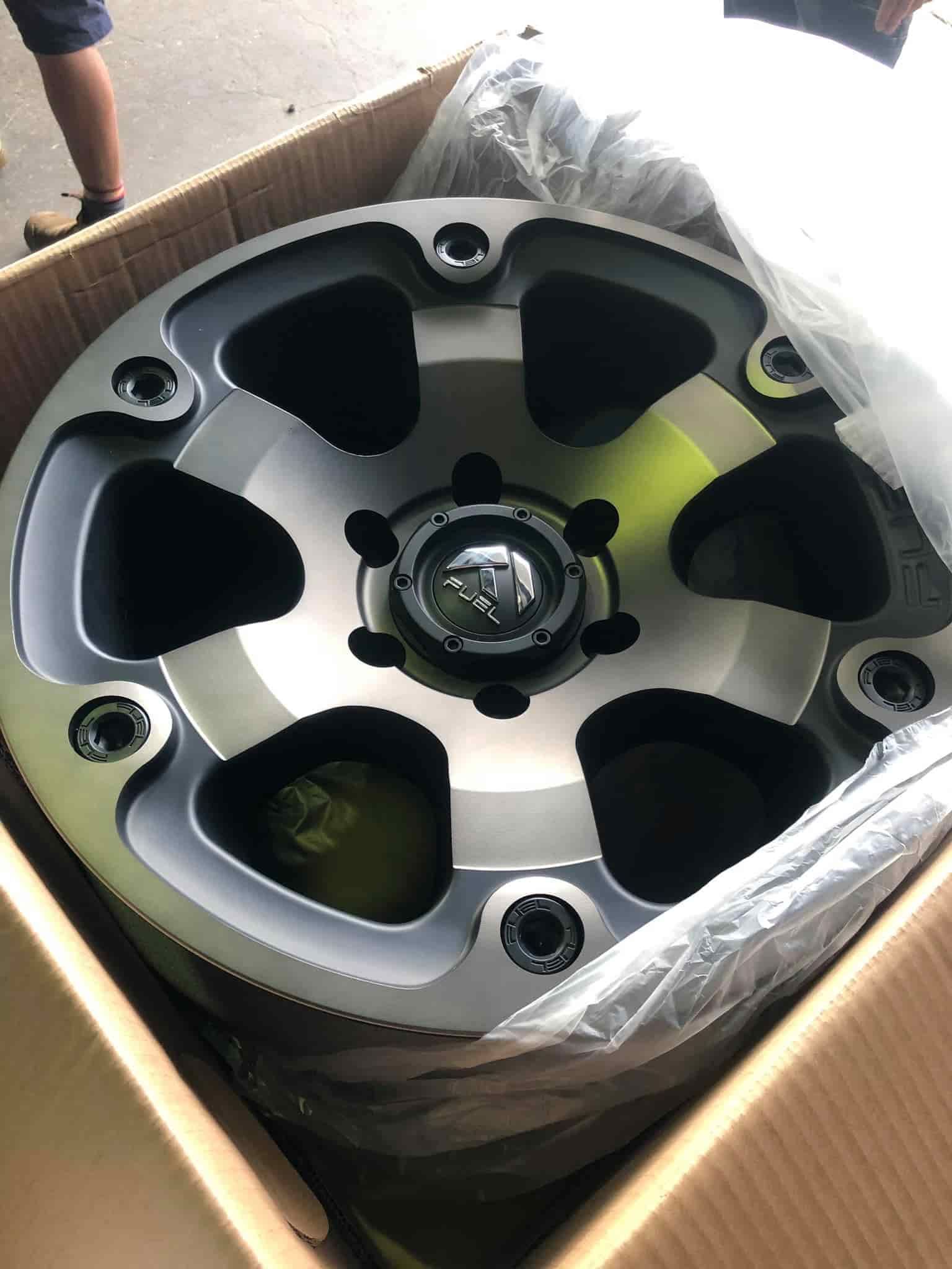 A Close-Up of A Wheel in A Cardboard Box — Torque Tyres & Trailer Spares Cairns in Cairns, QLD