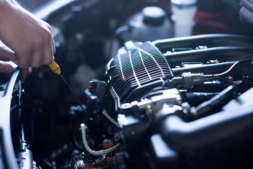 Checking a Car Engine with A Screwdriver — Torque Tyres & Trailer Spares Cairns in Cairns, QLD