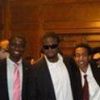 A group of men in suits and ties are posing for a picture.