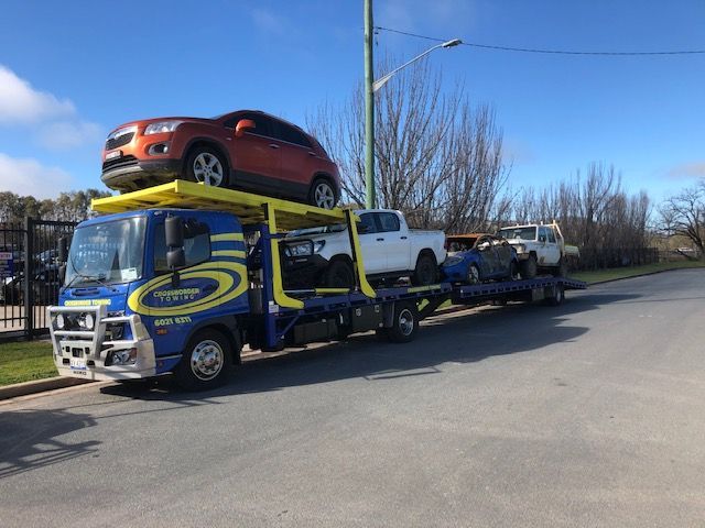 A Tow Truck is Towing a Car on the Highway — Crossborder Towing in Thurgoona, NSW