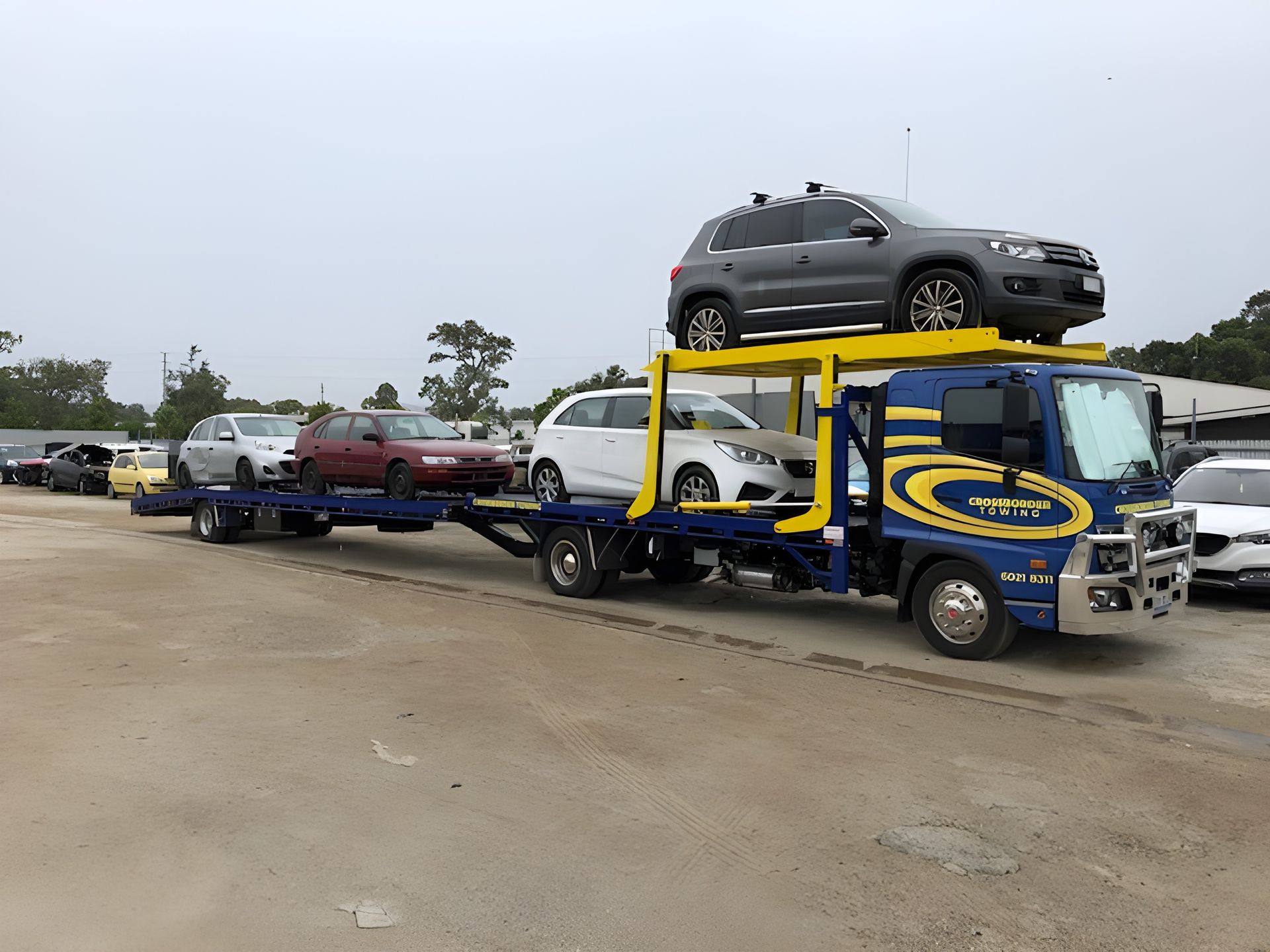 A Tow Truck is Carrying a Stack of Cars on Top of It — Crossborder Towing in Yackandandah, VIC