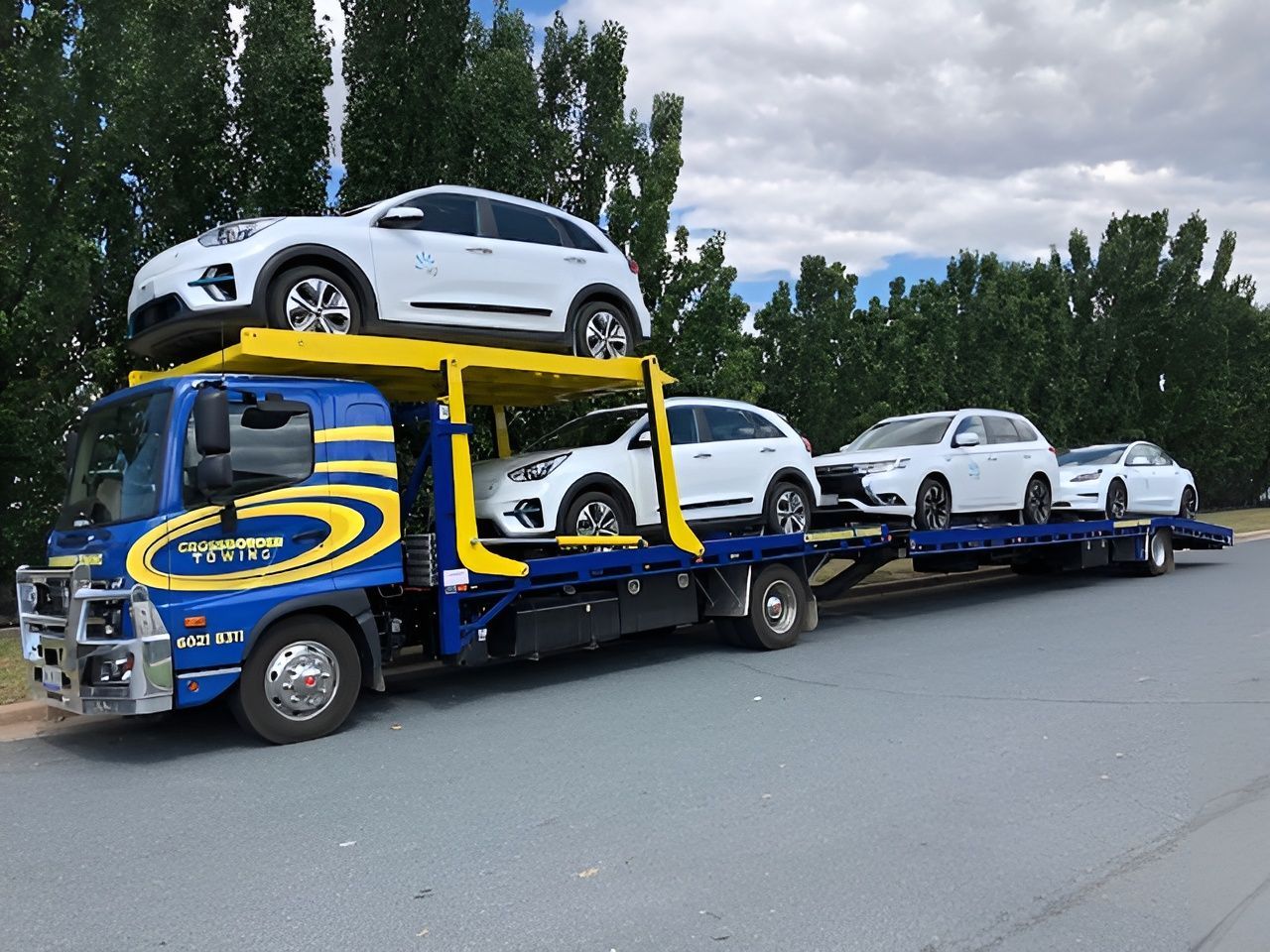 A Tow Truck is Carrying a Bunch of Cars on Top of It — Crossborder Towing in Mount Beauty, VIC