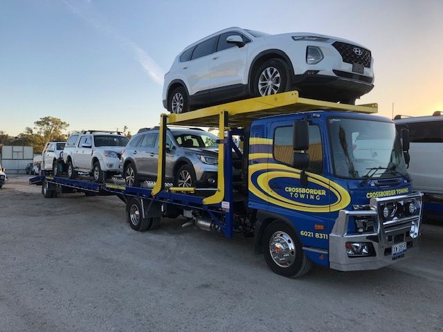 A Tow Truck is Towing a Car on the Highway — Crossborder Towing in Yackandandah, VIC
