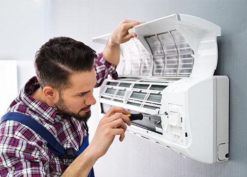 Repairing Air Conditioner With Screwdriver — Bartlett, TN — EnviroUSA