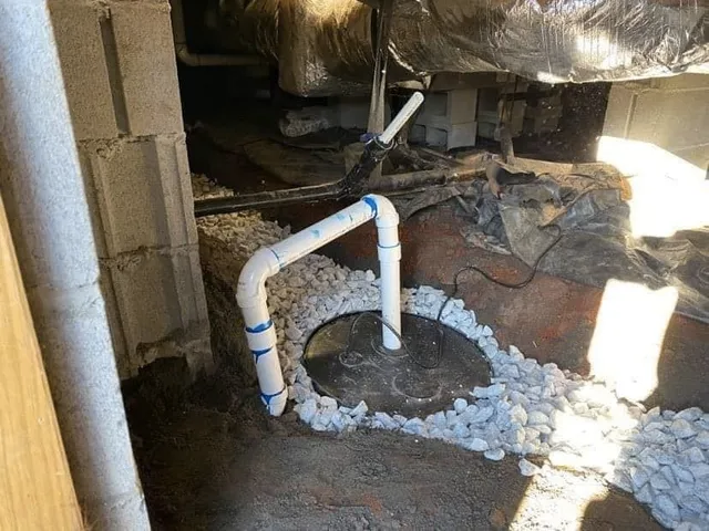 A drain pipe is being installed in a basement.