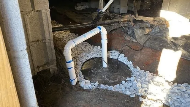 A white pipe is sitting in a hole in the ground in a basement.