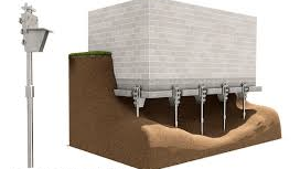 A drawing of a house sitting on top of a dirt hill next to a pole.